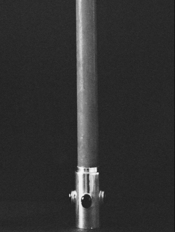 Lit candles with silver holders on a black background